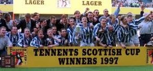 The Kilmarnock team celebrate with the trophy.