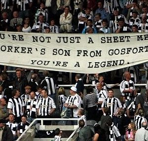 newcastle united fans holding banner